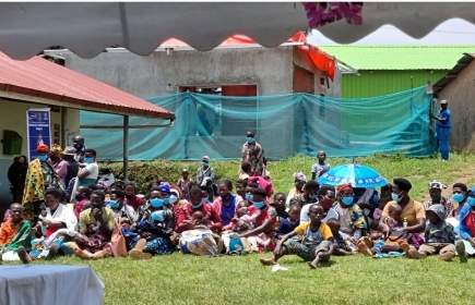 Eine Gruppe von Müttern und Kindern wartet vor dem Butanda HC III, um die Reisegruppe zu begrüssen. Foto: Urs Klemm